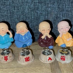Set of Four Monk Figurines with Spring Base